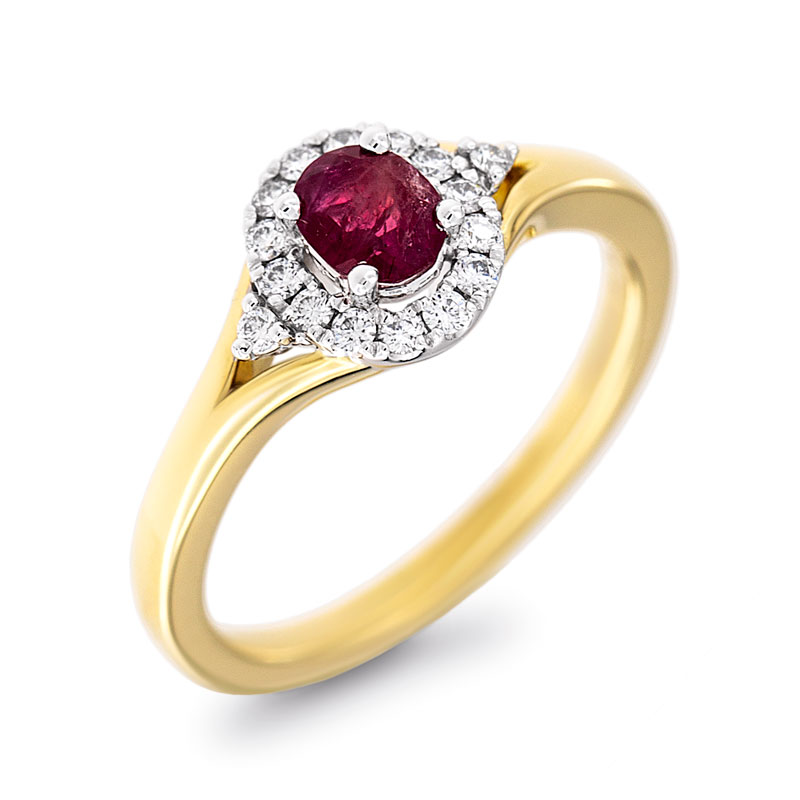 Photo of an oval red beryl halo style ring in yellow gold.